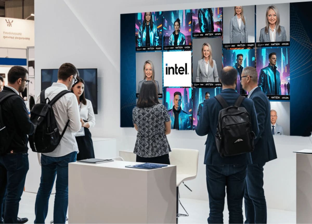 Trade show booth visitors watching a wall of screens showing AI portraits generated by guests at an Intel activation