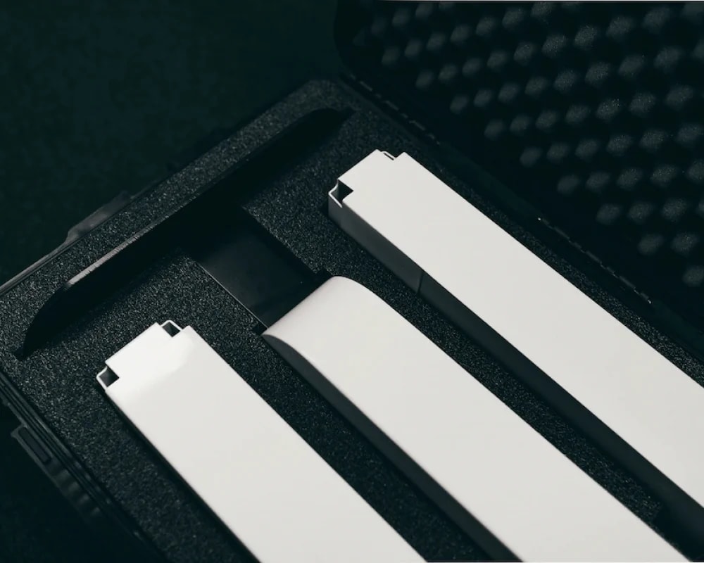 White selfie station panels packed into the foam inserts of a black hard-shell travel case
