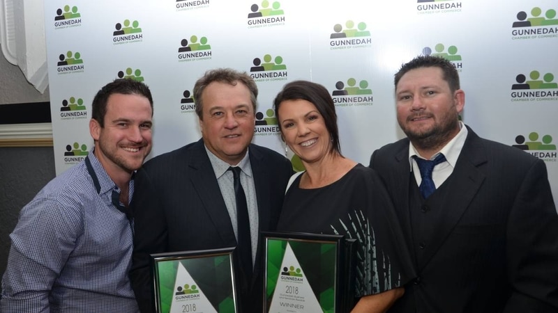 Jason and Jacinta holding a plaque of award