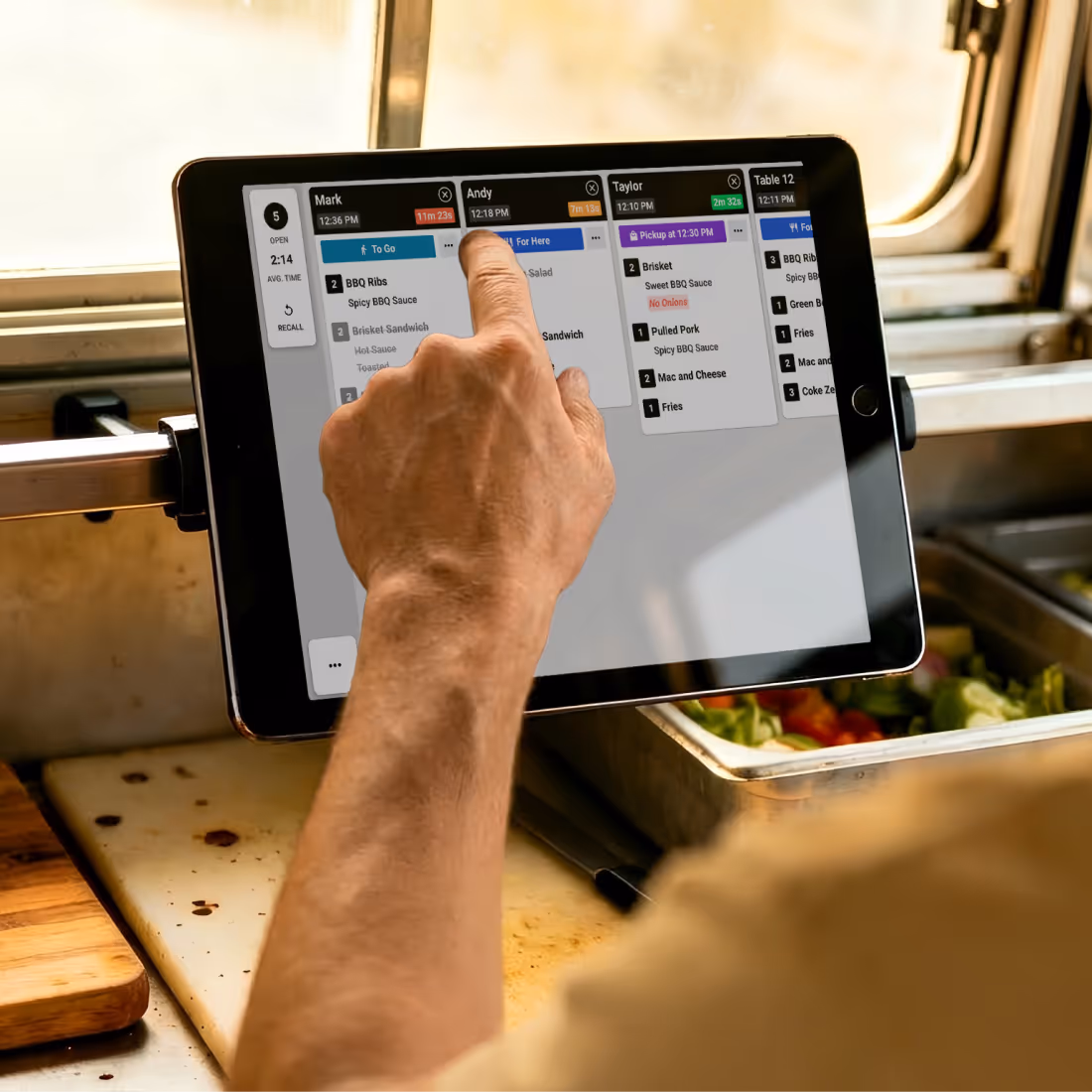 Smiling barista in an apron holding a receipt with on-screen toggles for enabling automatic printing and printing options for Here, Drive Thru, and Pickup.
