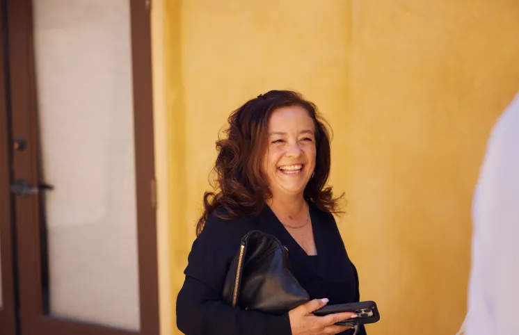 A therapist with dark hair, laughing