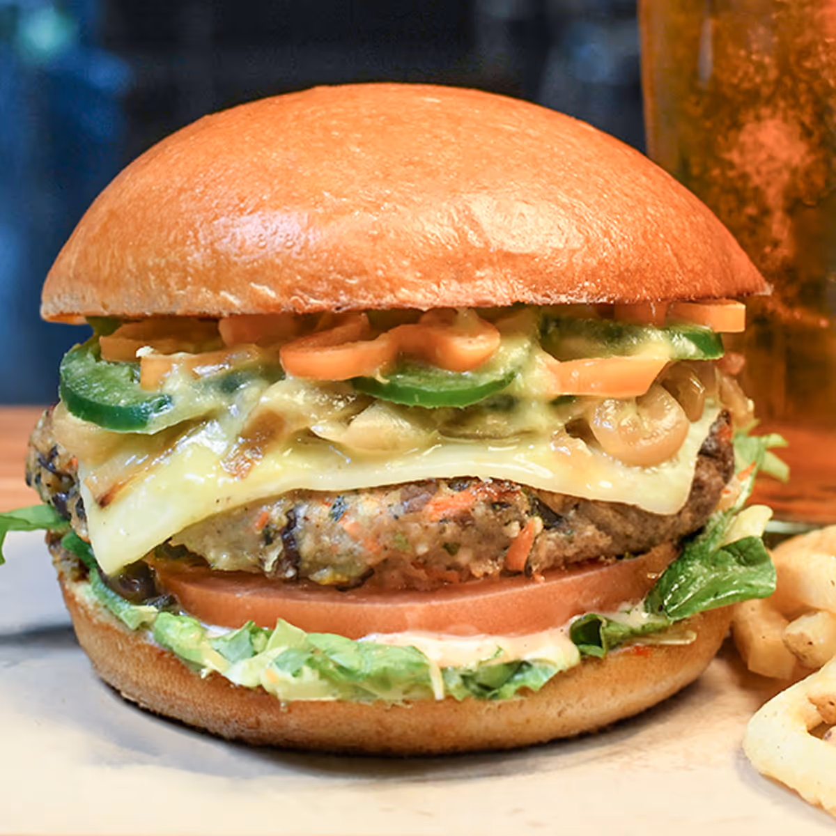 Veggie burger topped with pepper jack cheese, jalapeños & habaneros, caramelized onions, spicy salsa verde, lettuce, tomato & chipotle aioli sauce.