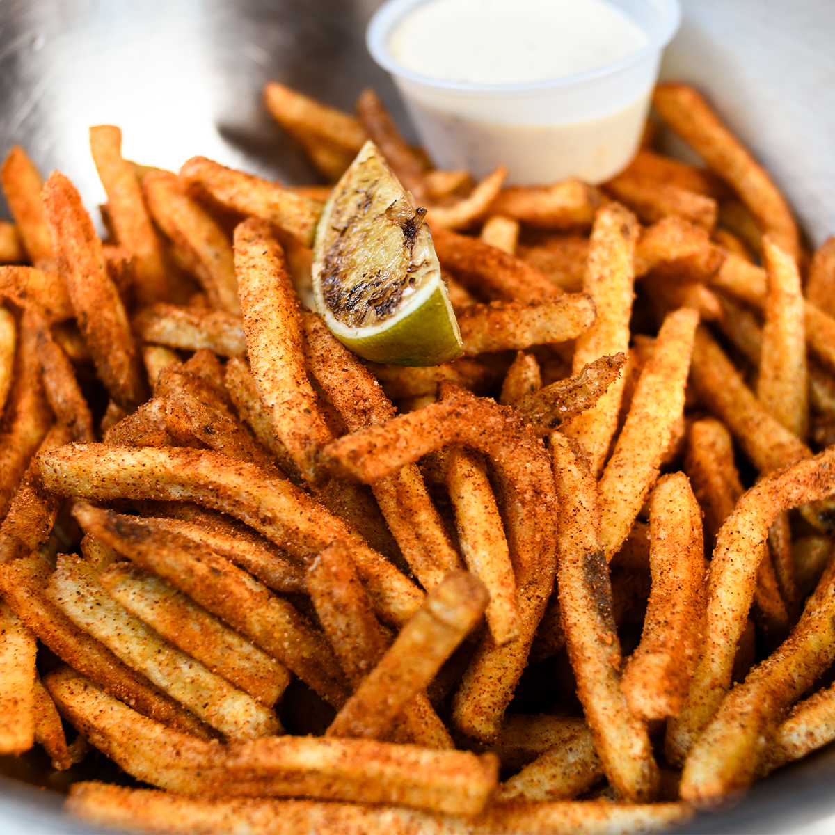 Crispy Golden Fries loaded with Fiery Fuego Seasoning, tossed in a Tangy Chili-Lime blend
