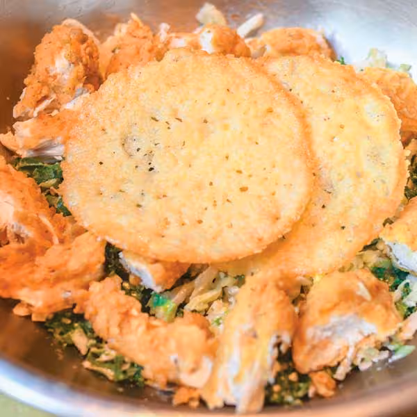 Packed with protein (51g) & fiber this bowl features House greens tossed in creamy caesar dressing, topped with crispy chicken tenders, grated parmesan & parmesan cheese crisps