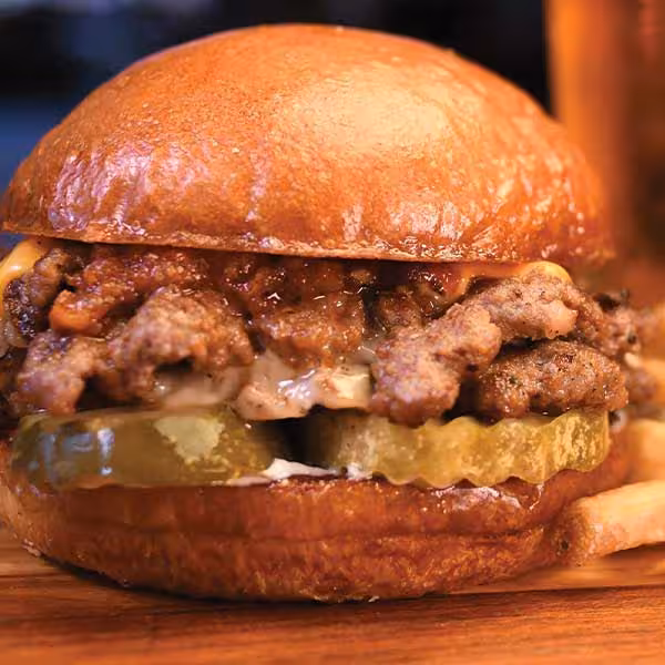 Two beef smash patties topped with both white & yellow American cheeses, tomato bacon jam, mustard grilled onions, pickles & mayo.