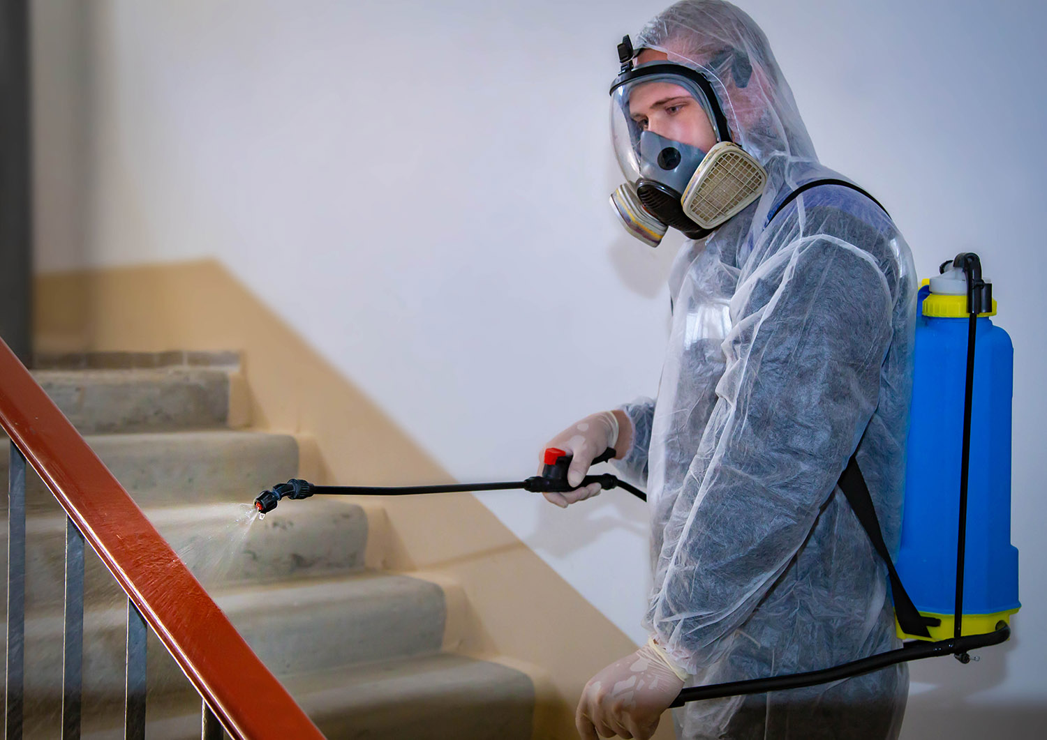Man wearing a complete PPE and performing Bio-Hazard cleaning