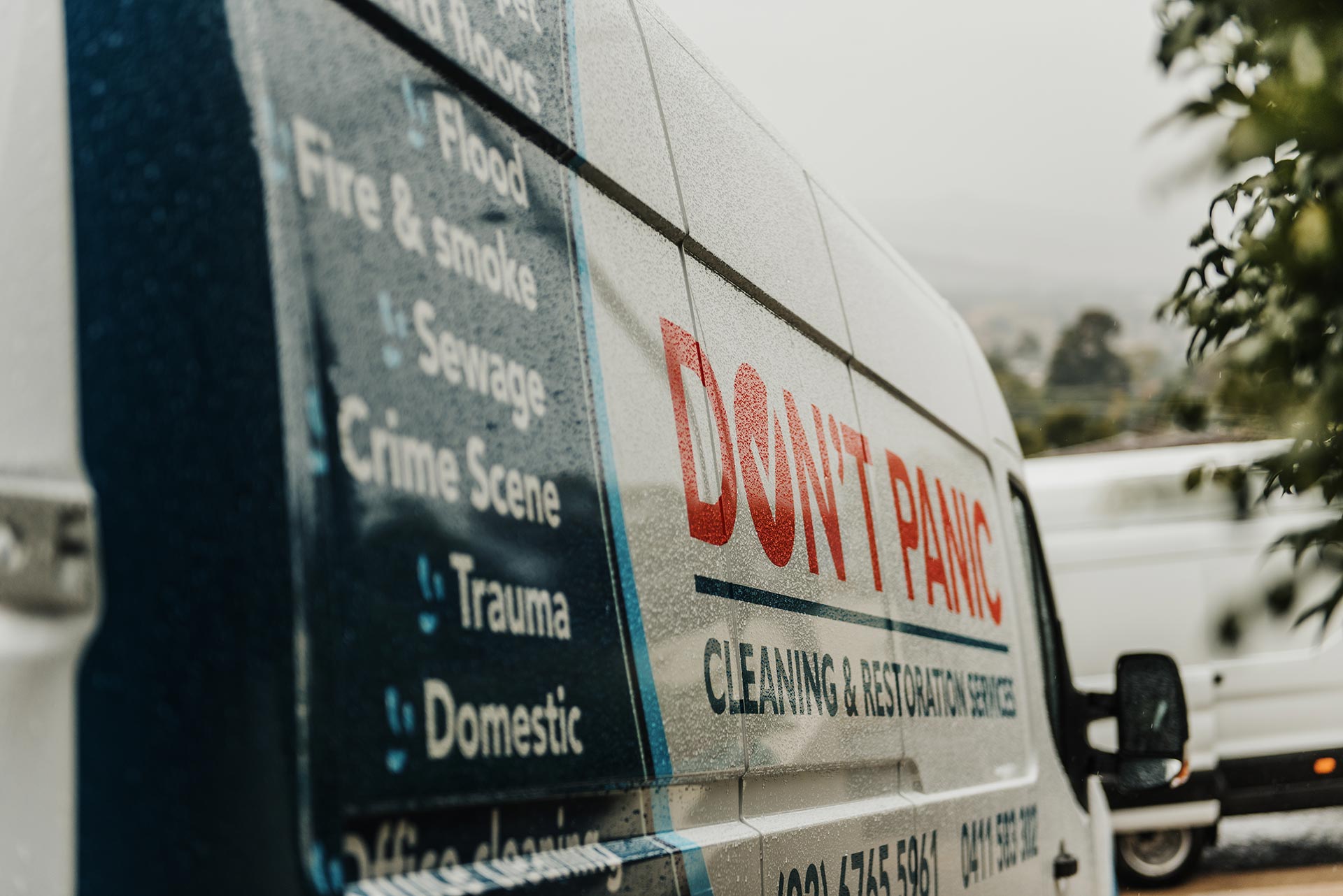 Van with print of "Don't panic cleaning and restoration services"