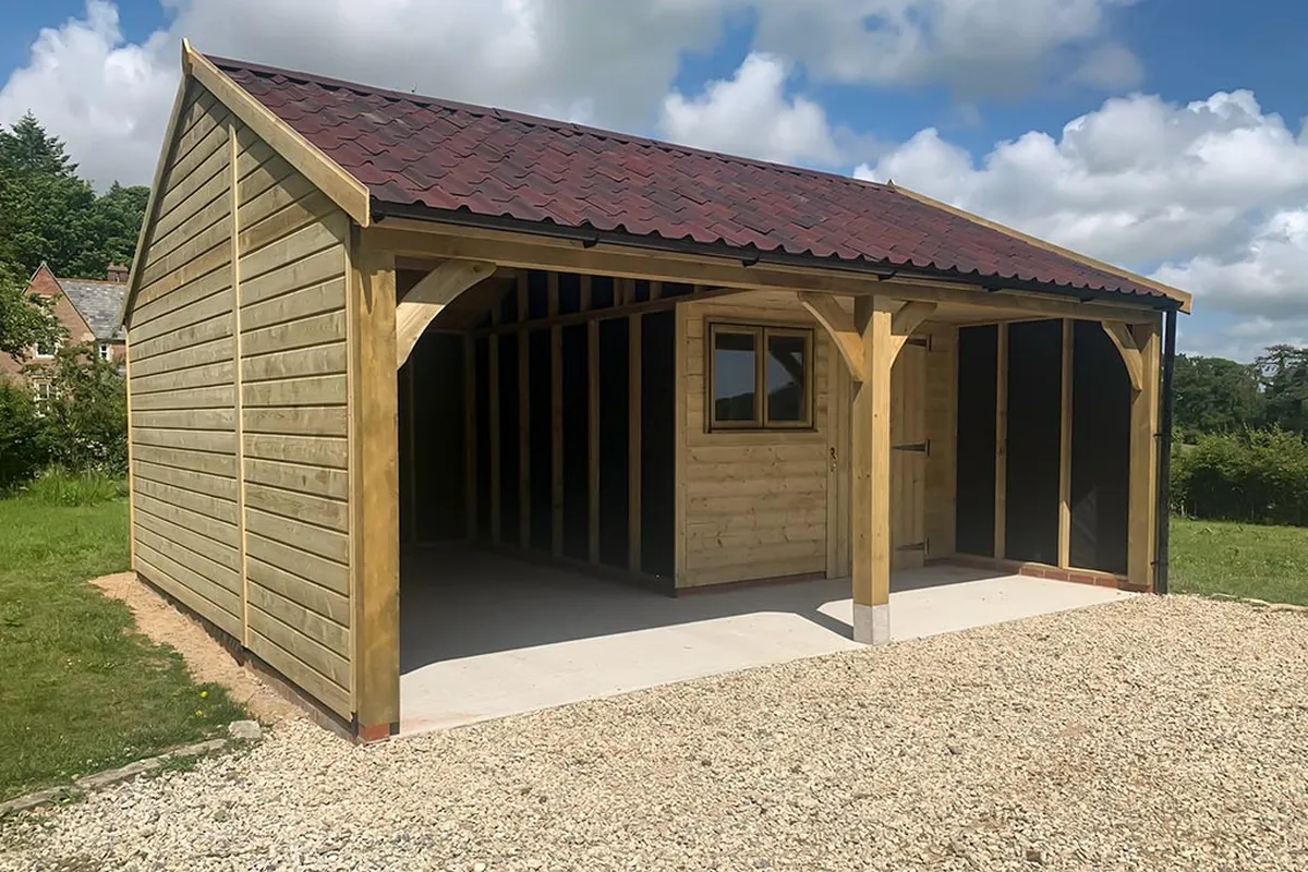 Timber garage showing framing and cladding specification that affects cost
