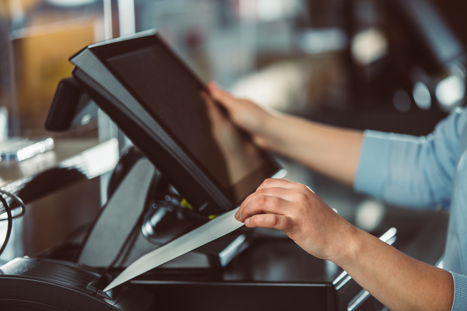 A cashier manning a POS system