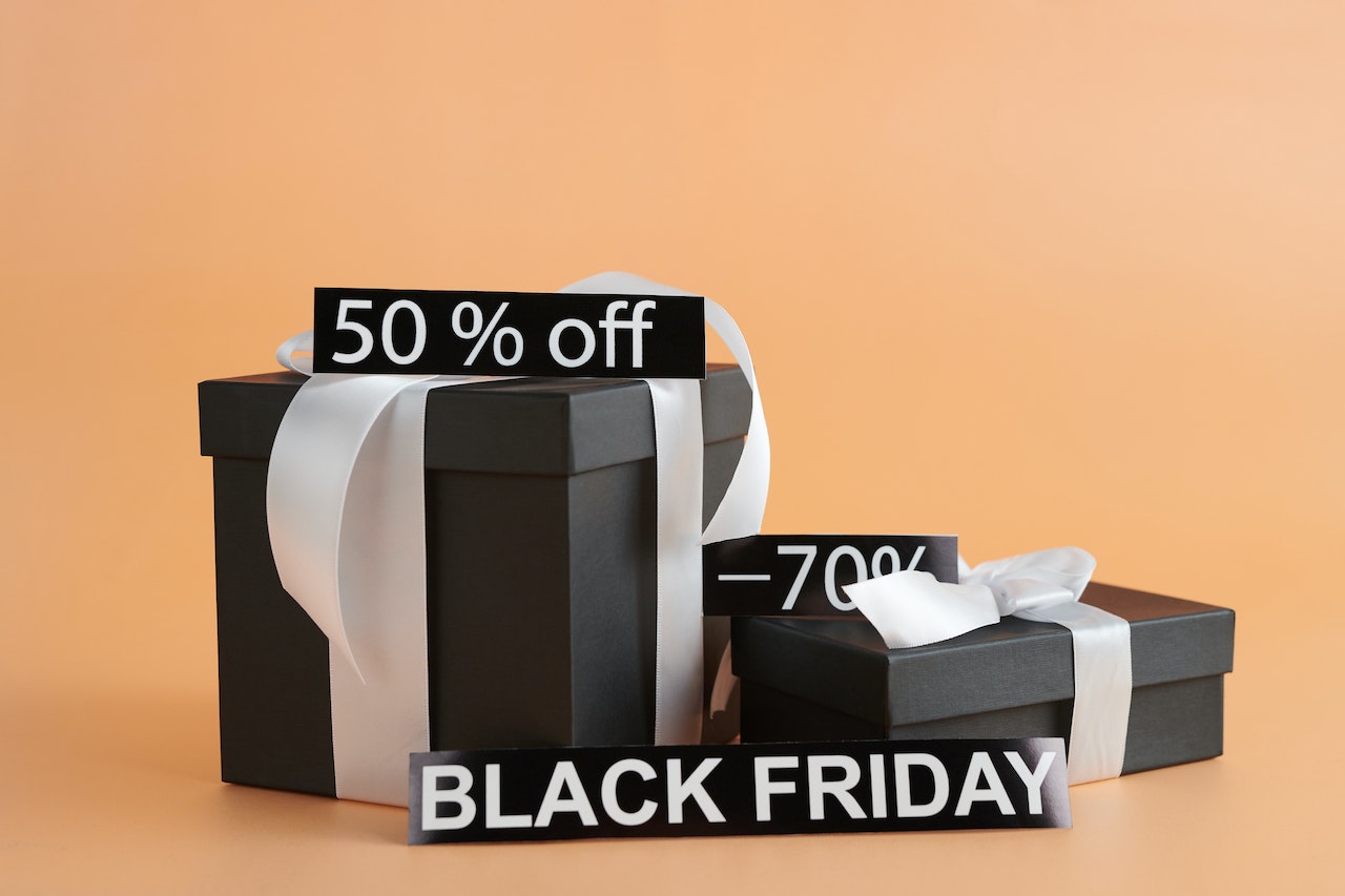 A stack of black gift boxes with Black Friday and discount signs