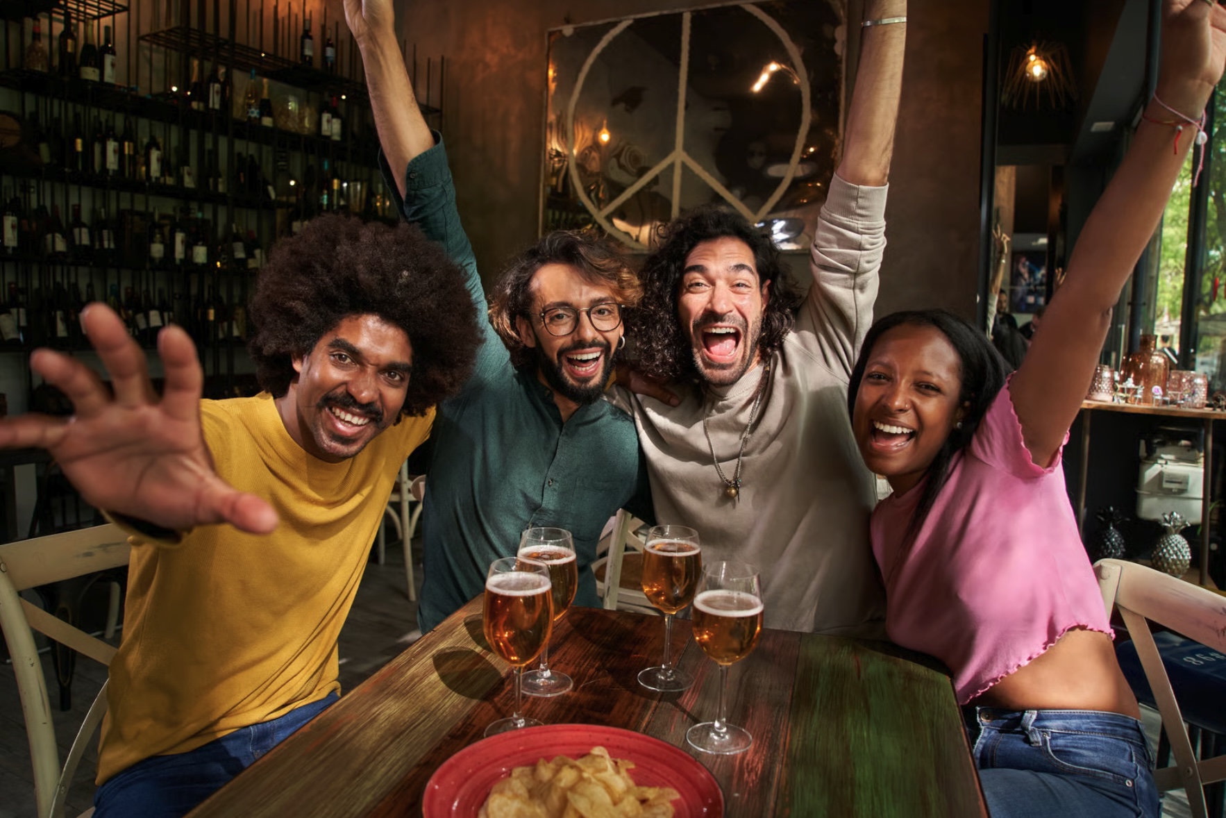 A group of four friends celebrate winning at a pub
