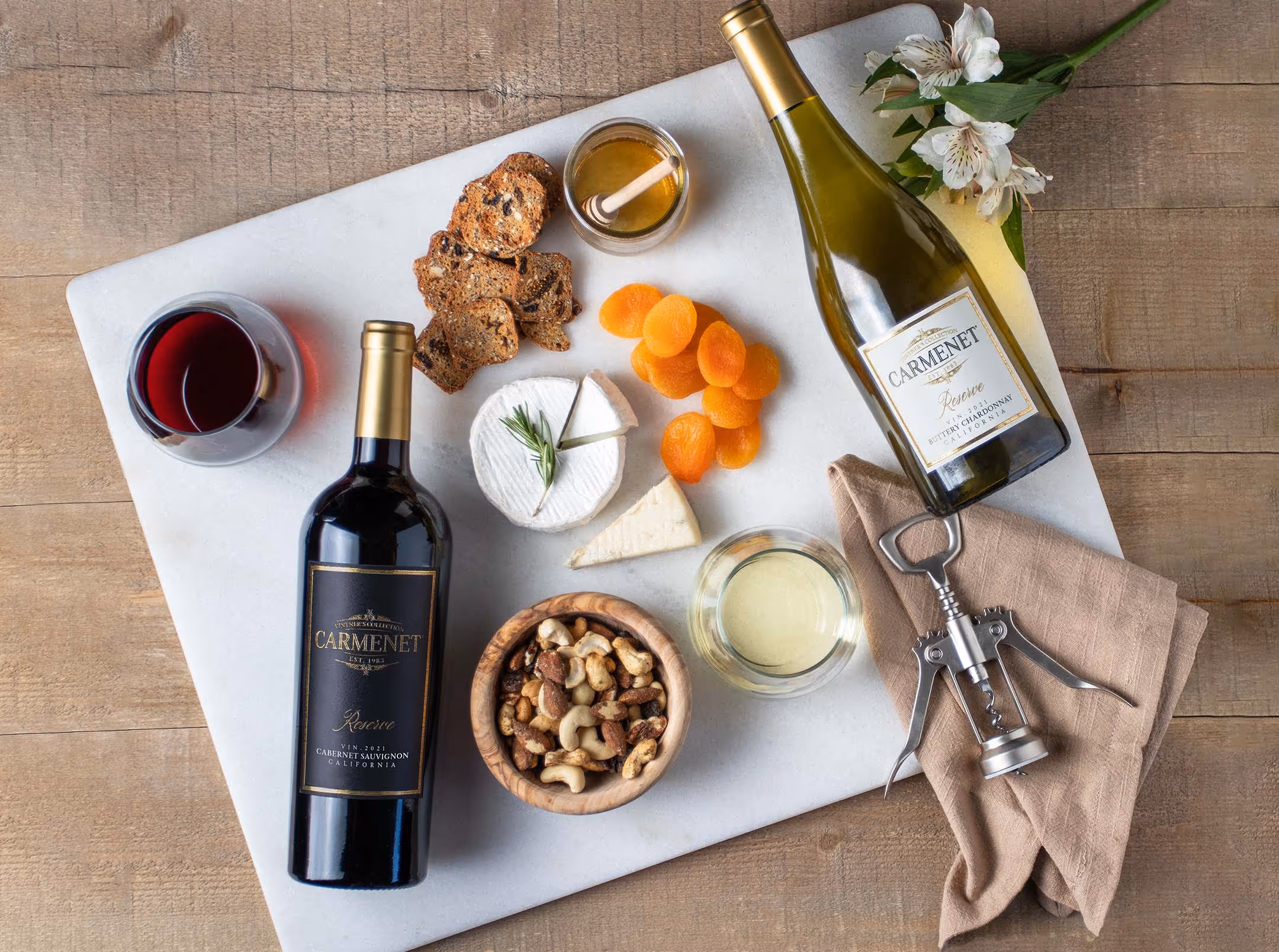 Bottles of Carmenet wines on a marble charcuterie board 