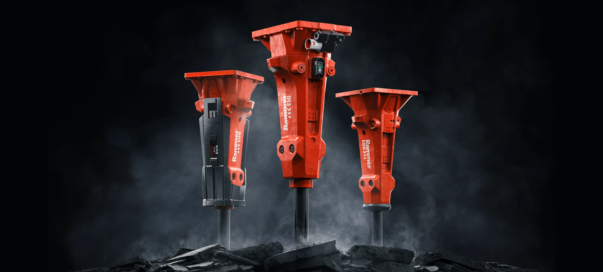 Three red heavy-duty hydraulic rammers standing on cracked ground with a smoky black background.