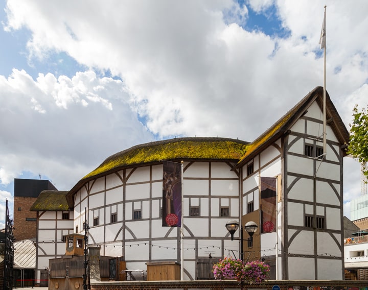 Elizabethan playhouse, features a thatched roof and timber-framed walls.