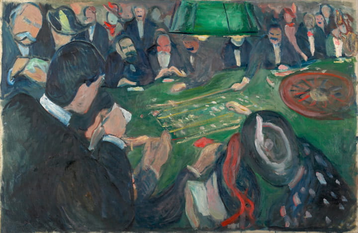 Group of people gathered around a roulette table with a green lamp overhead in a dimly lit room