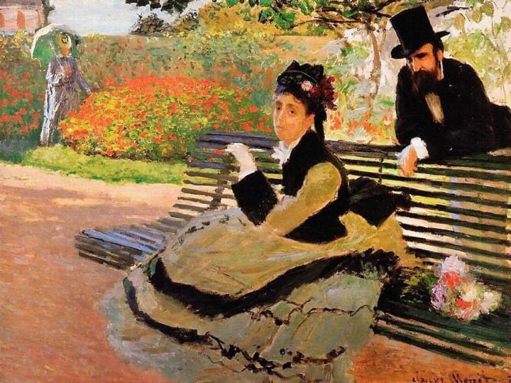Woman in a dress and hat sitting on a garden bench with a man in a top hat leaning on the bench behind her and a woman walking in the background near flower beds
