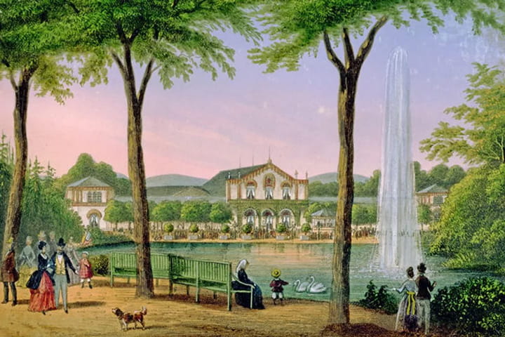 Park scene with a large fountain, swans on a pond, people walking and sitting on benches, and a building in the background