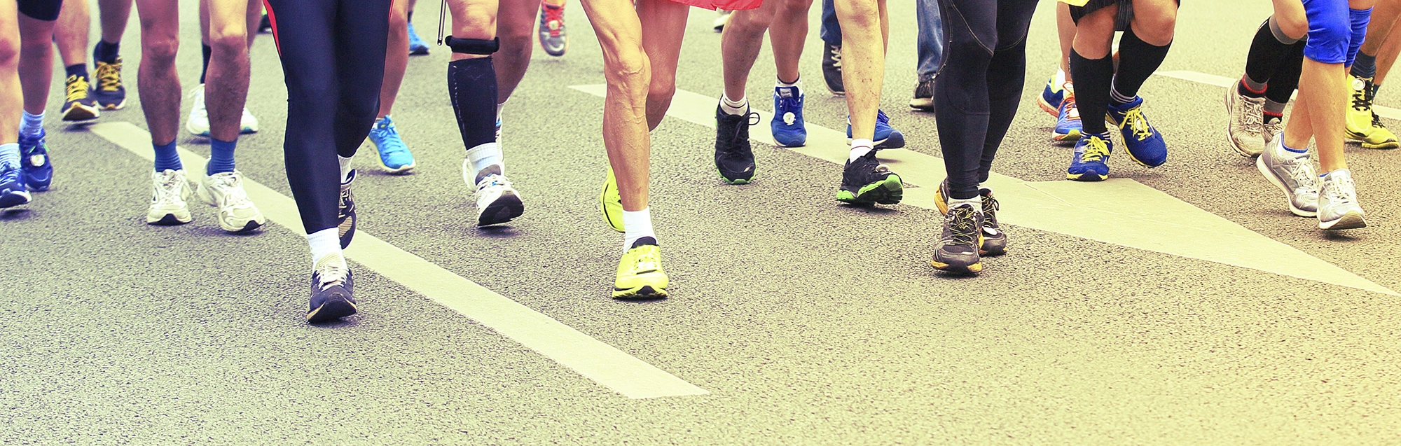 Runners legs on street wearing sneakers