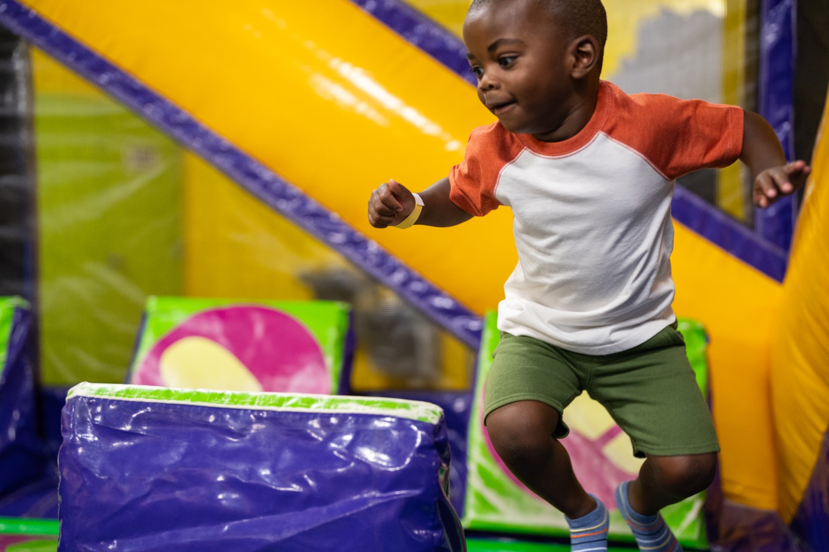  A child playing in Monkey Joe's during a photo shoot to produce content for social media and other promotional materials.
