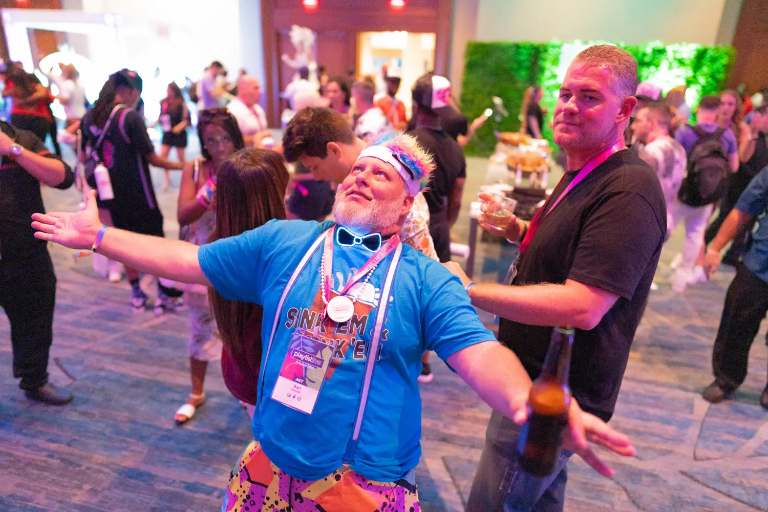 Attendees dancing and milling about during event coverage of Meet Me's VIP party at Playlist Live.