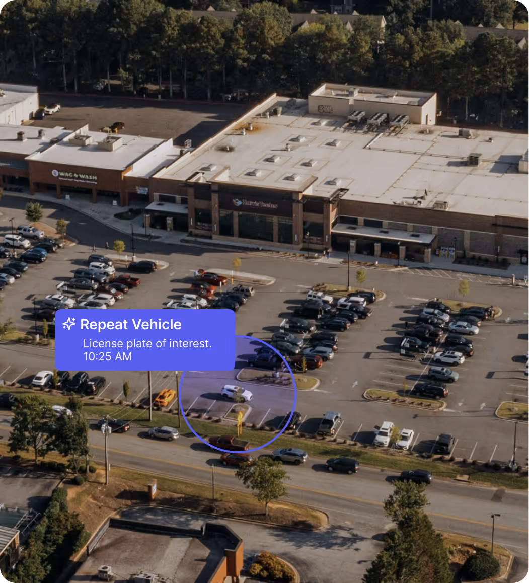 Aerial view of a parking lot with many cars and a white vehicle highlighted as repeat vehicle at 10:25 AM.