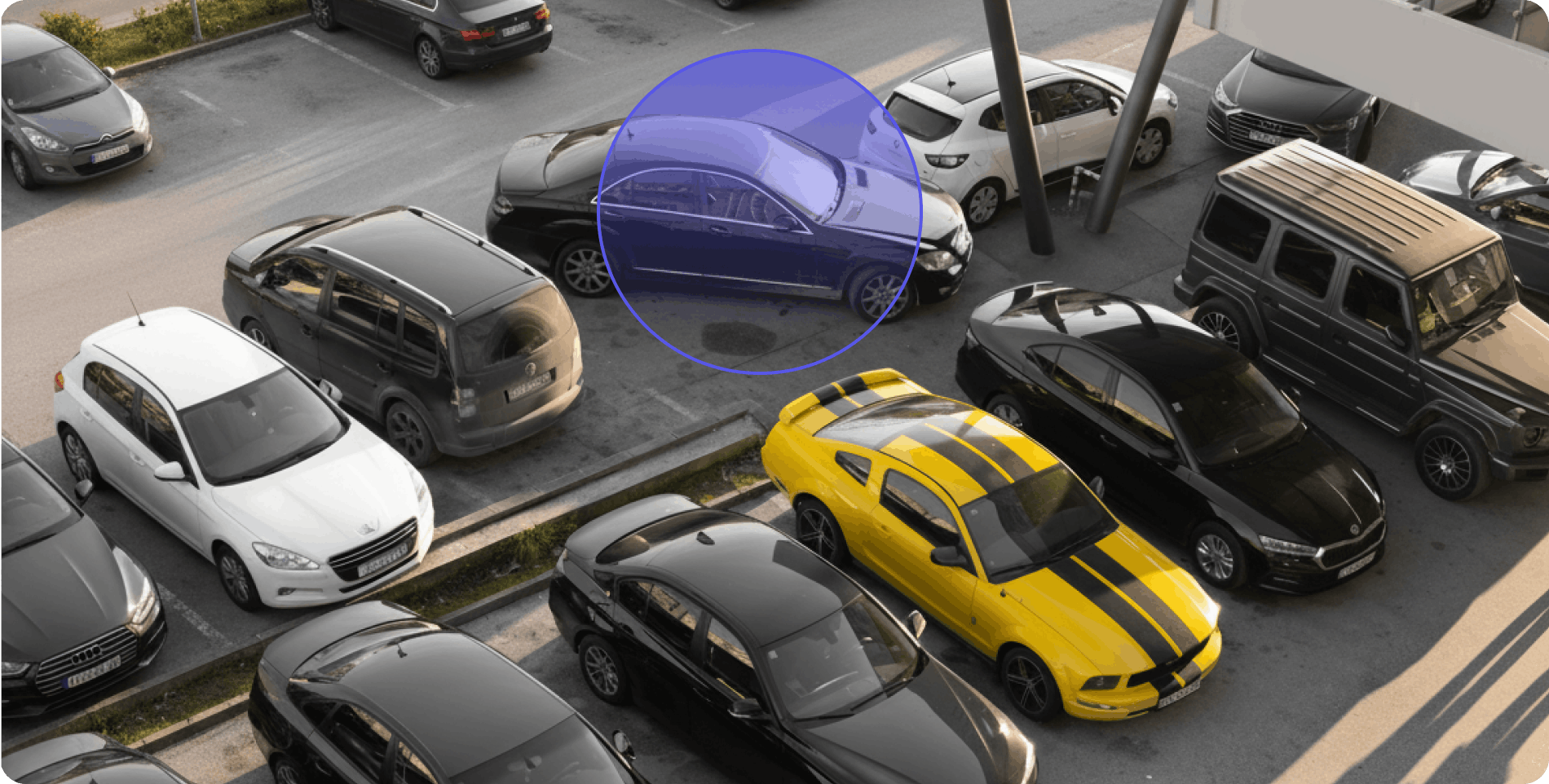 Aerial view of a large parking lot full of cars next to a warehouse building with shopping carts.