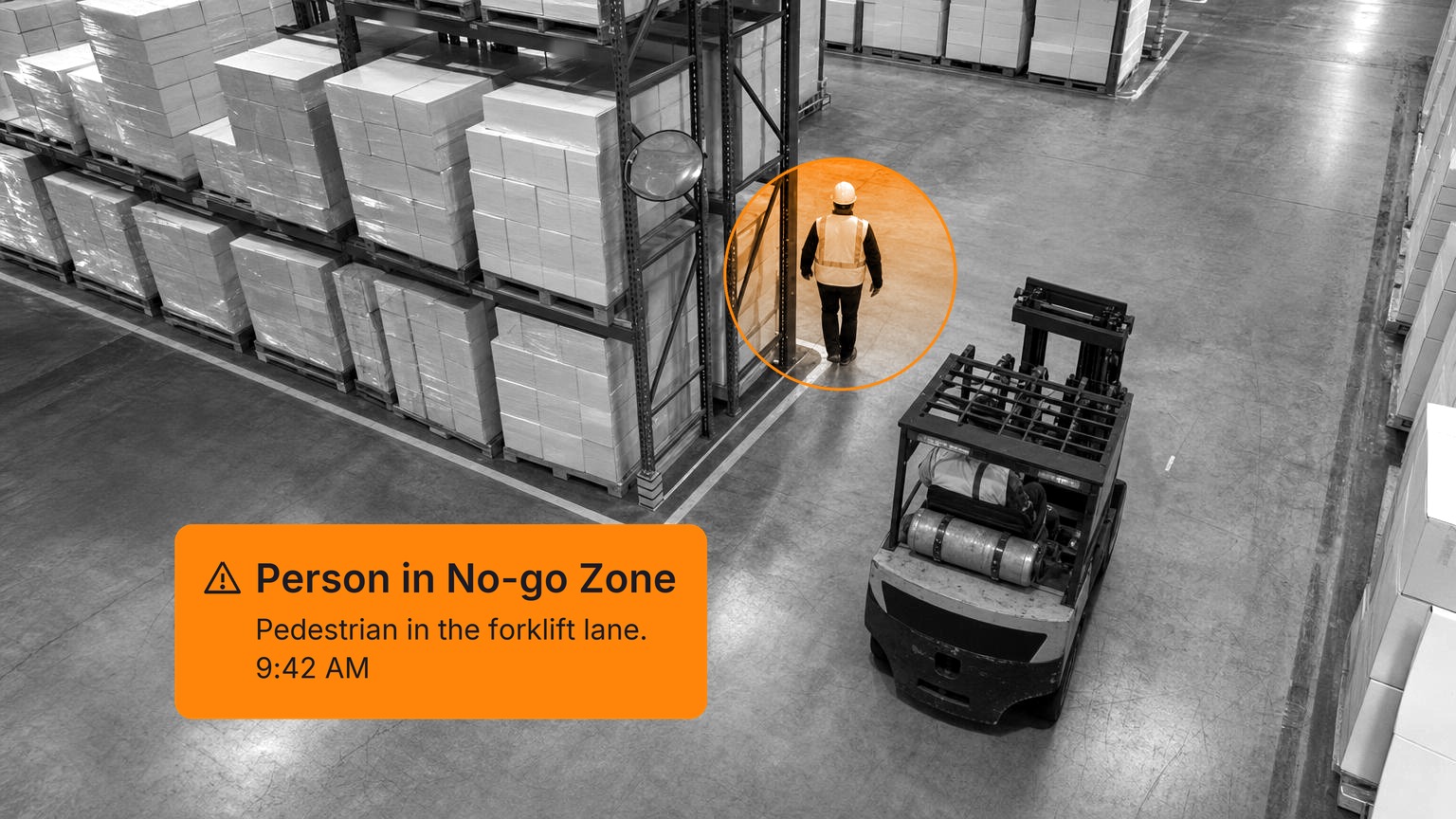 A worker in a hi-vis vest and hard hat walking out past the end of a pallet rack into the aisle of a finished-goods warehouse as a forklift drives up just behind him, in black and white with a Spot AI detection overlay.