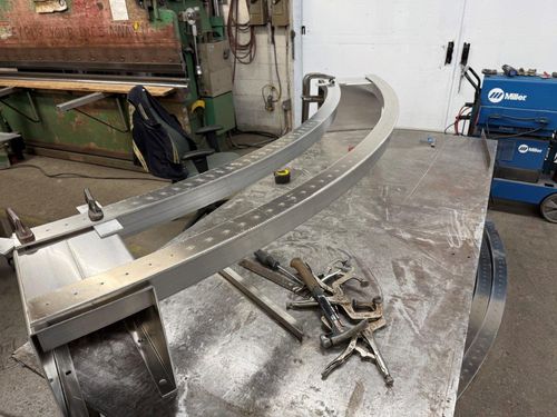 Curved aluminum bench frame. Arc cut with water jet.