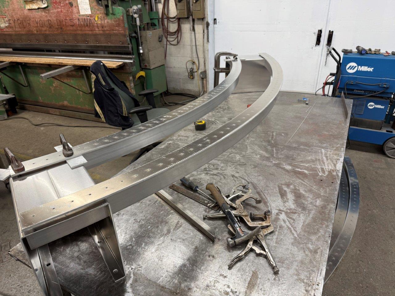 Curved aluminum bench frame. Arc cut with water jet.