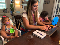 Rachel working at home with her kids
