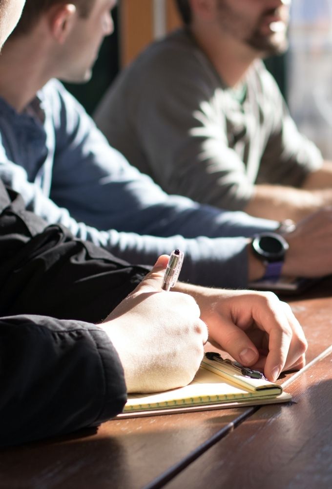 Men talking and writing