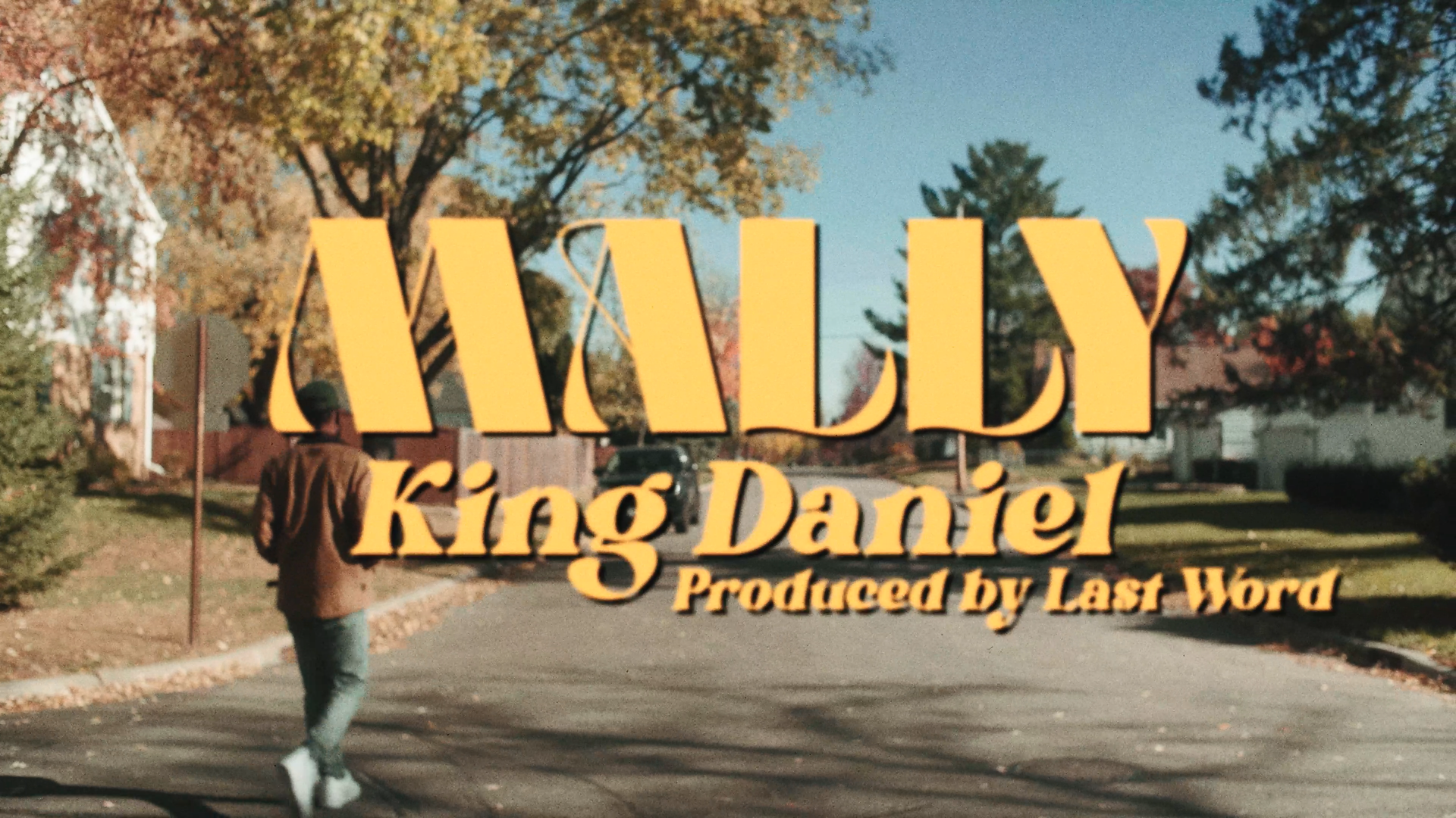 MaLLy walking on a suburban street with large yellow text overlay reading 'MALLY King Daniel Produced by Last Word'.