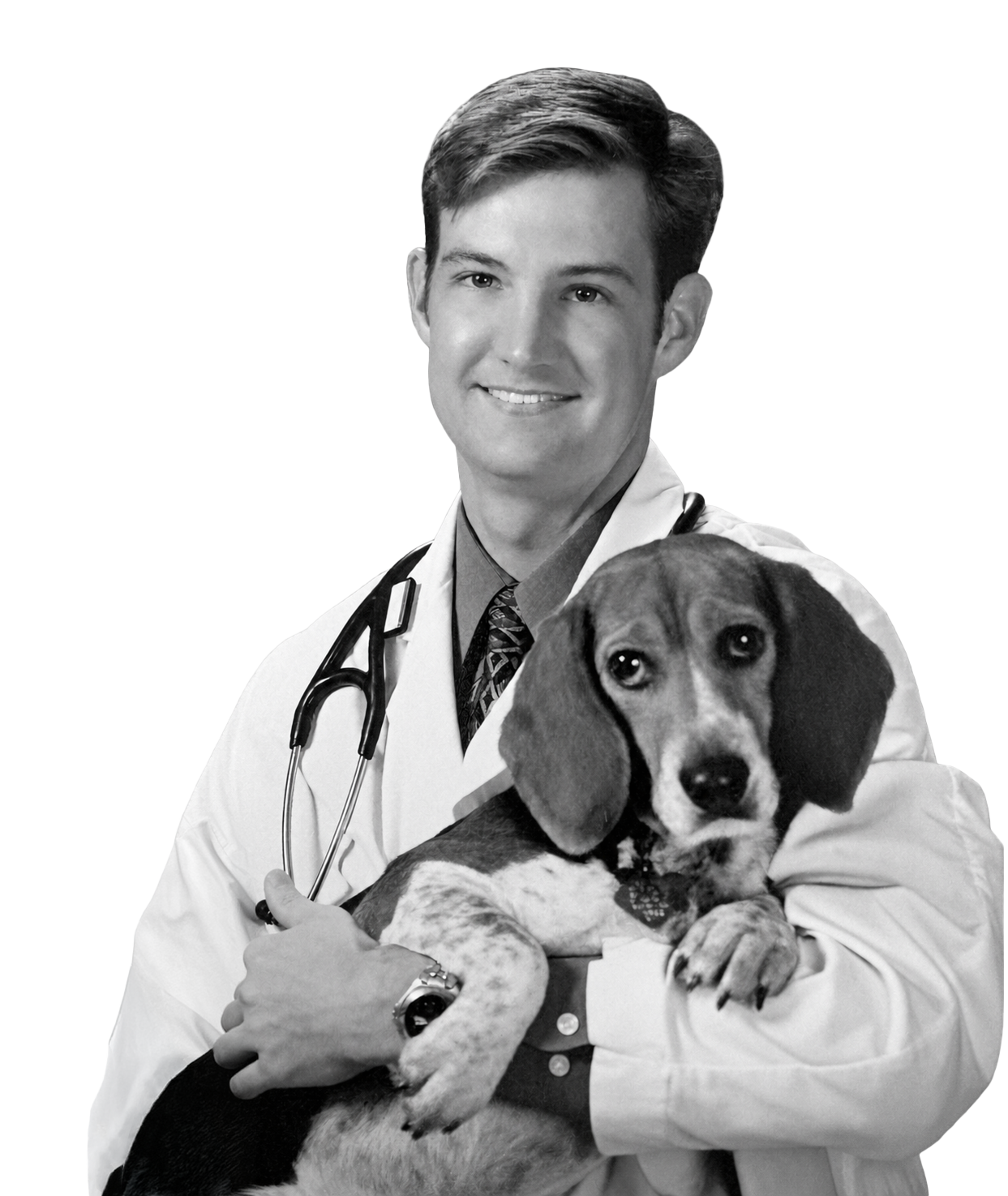 Dr. Clay Morris in a white coat holding a beagle