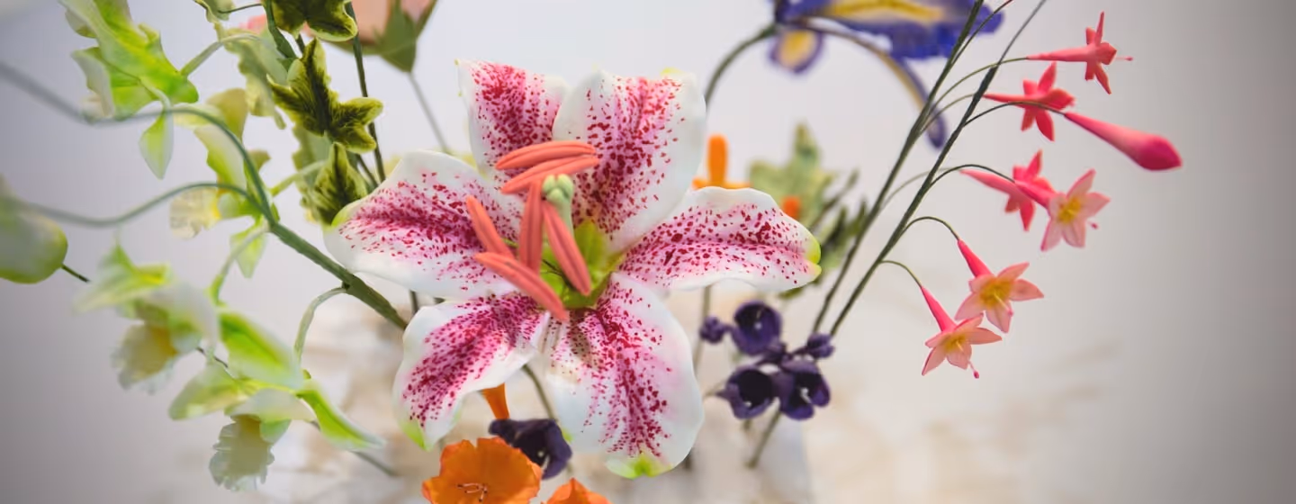 A close up of a vase with flowers in it.