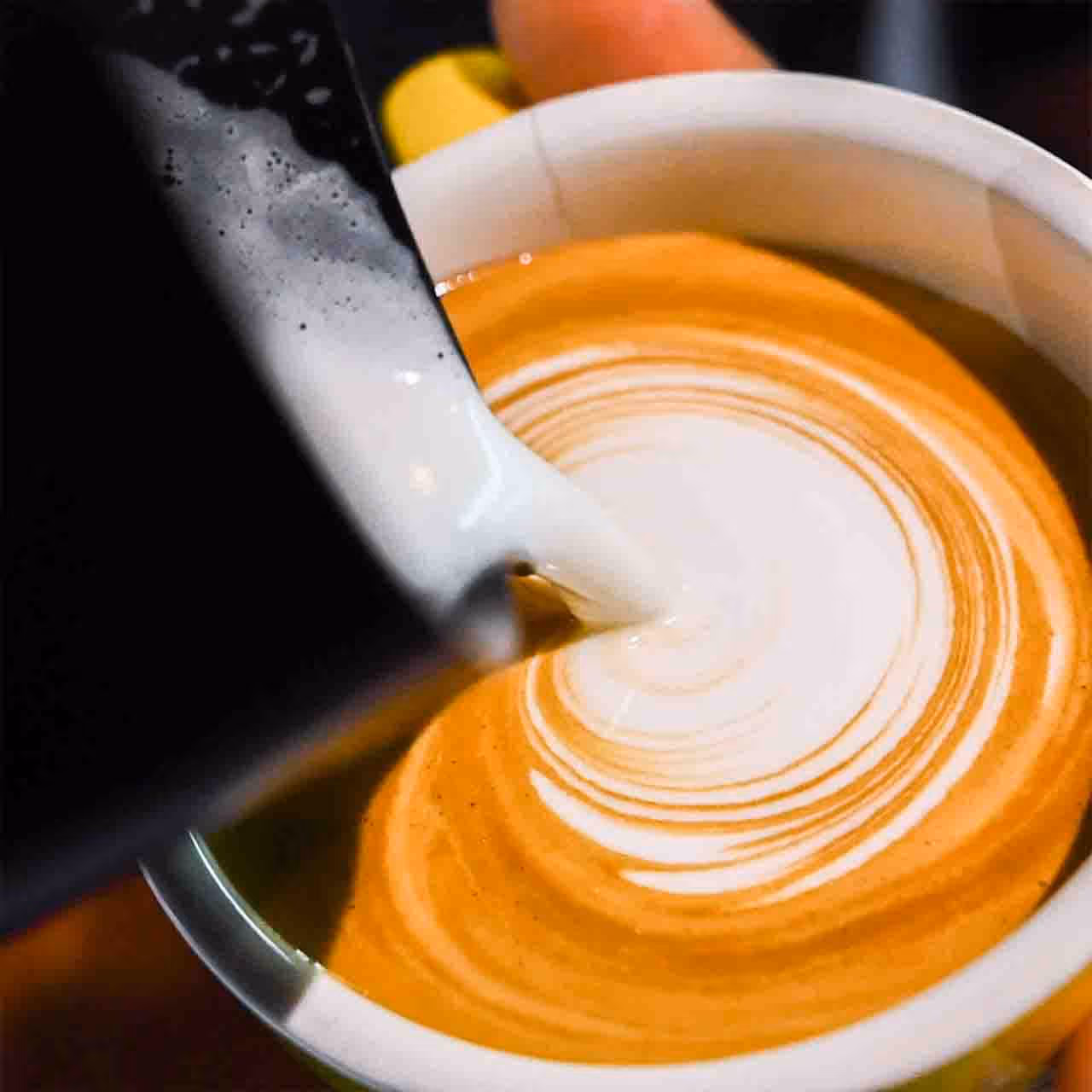 A cup of coffee with a spoon in it.