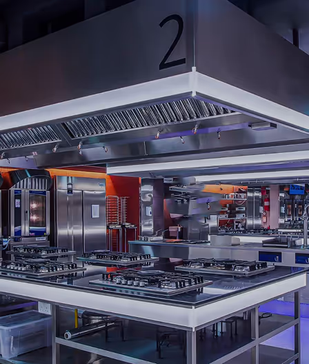 A kitchen with a lot of stainless steel appliances.