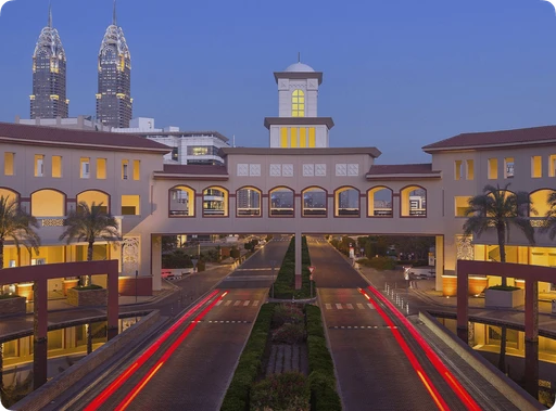 A large building with a clock tower in the background.