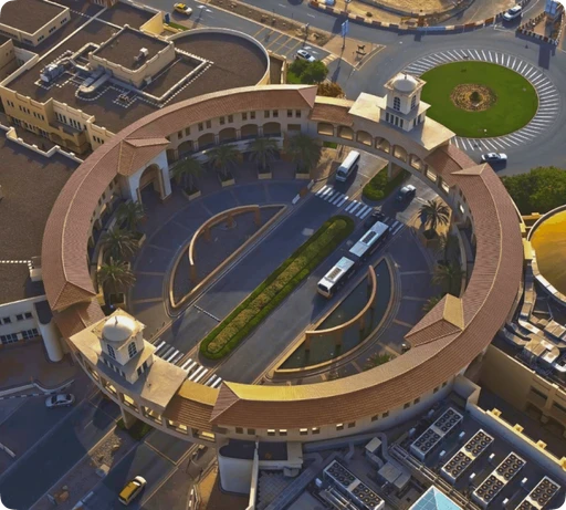 An aerial view of a circular building in a city.