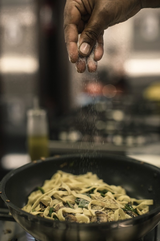 tossing pasta ingredients