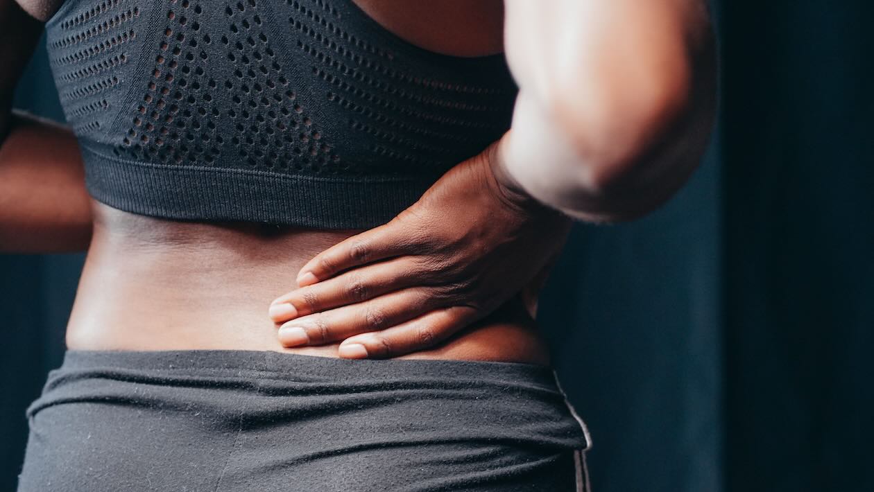 Person massaging painful hip joint