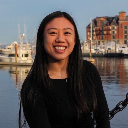 Photo of Thuy-Vy Nguyen standing by a harbor