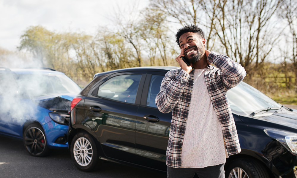 Man on phone after car accident