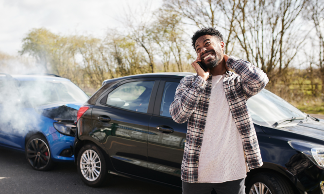 Man on phone after car accident