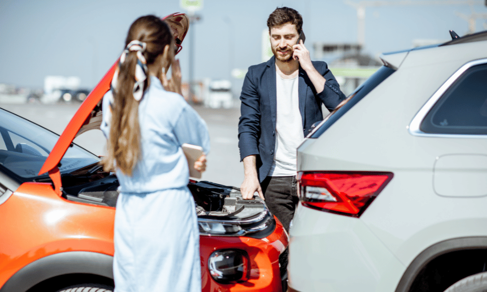 Man and woman conversing after a car accident
