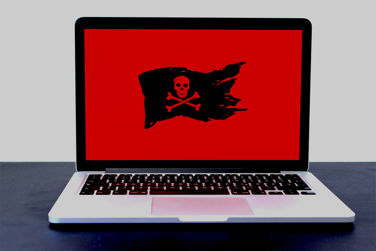 Imagem de um notebook dominado por um vírus e malware