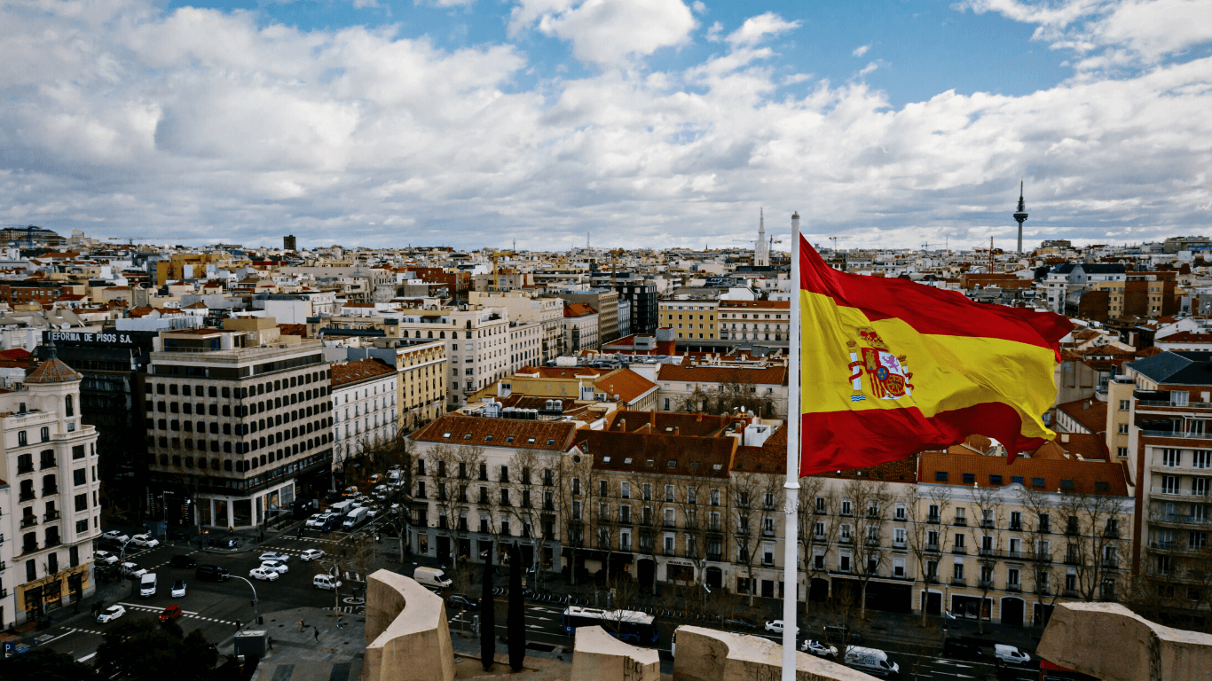 Bandeira espanhola com cidade de fundo