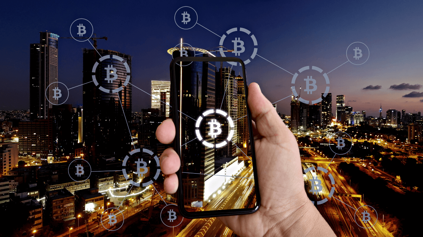 Celular com blockchain com uma cidade no fundo