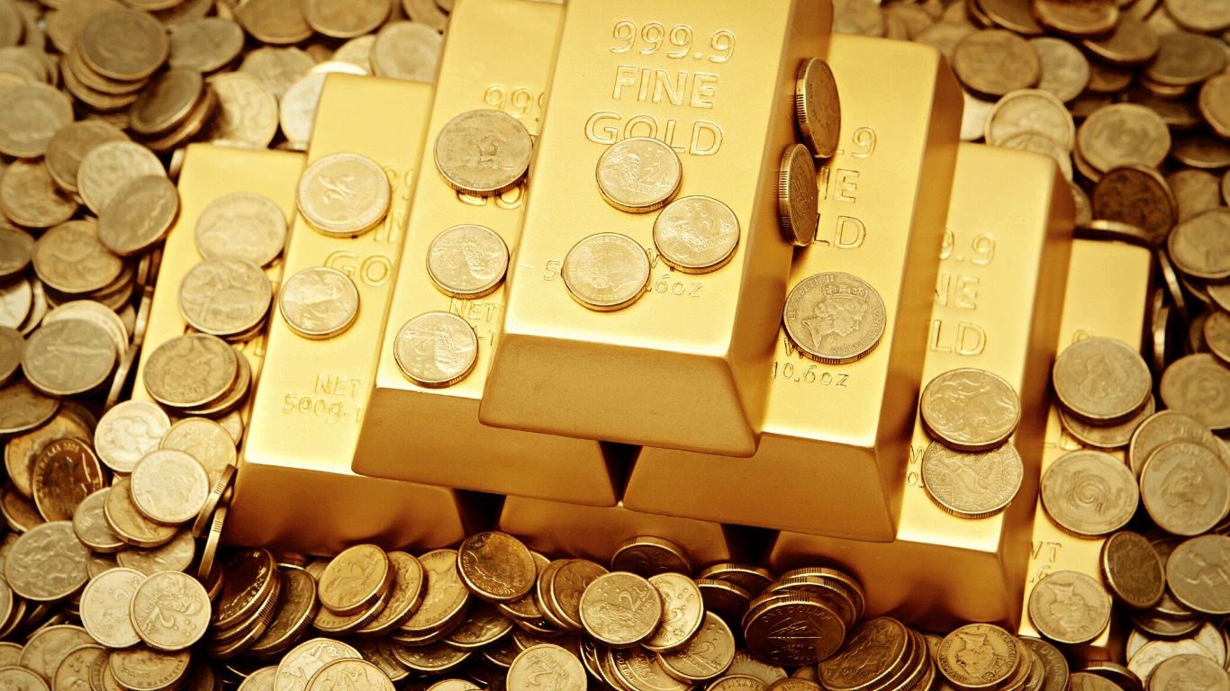 Barras de ouro com moedas de ouro