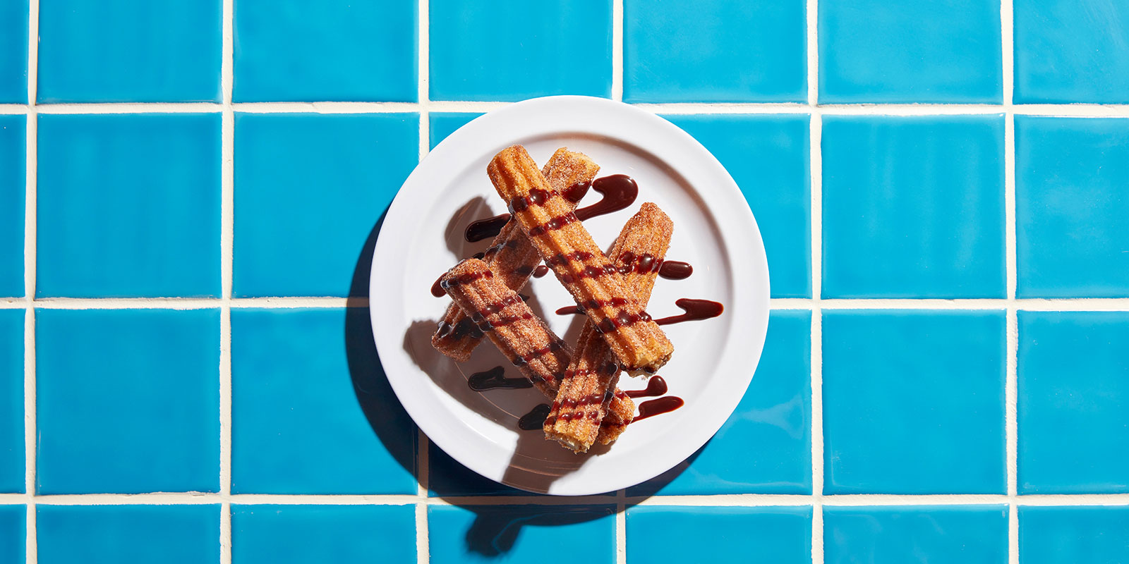 Crispy and soft Tiki Taco Churros with chocolate sauce