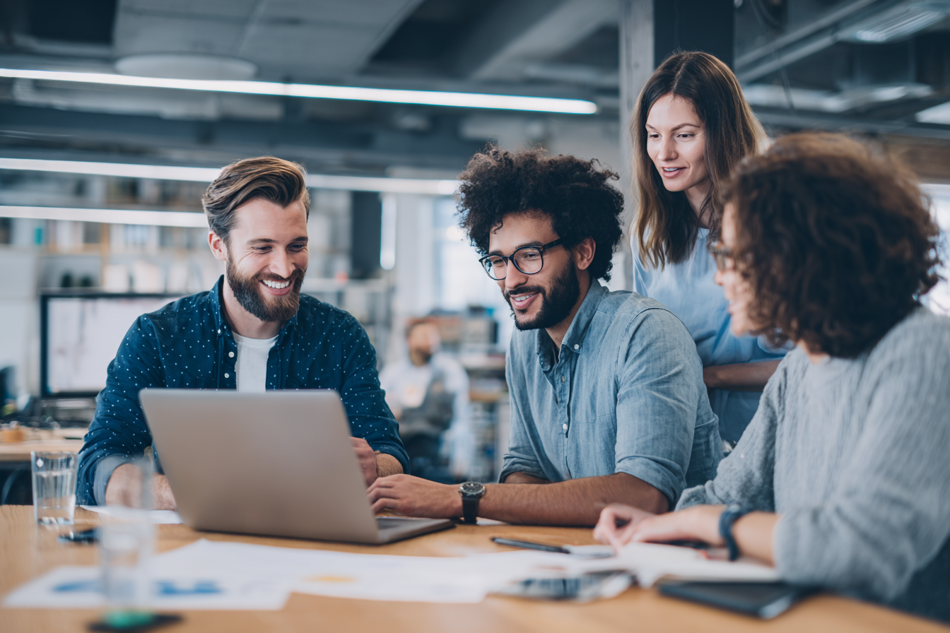 AboutIT consultant discussing IT strategy with a small business team around a table